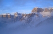 The clouds break to reveal the Sella Massif after a light snowfall